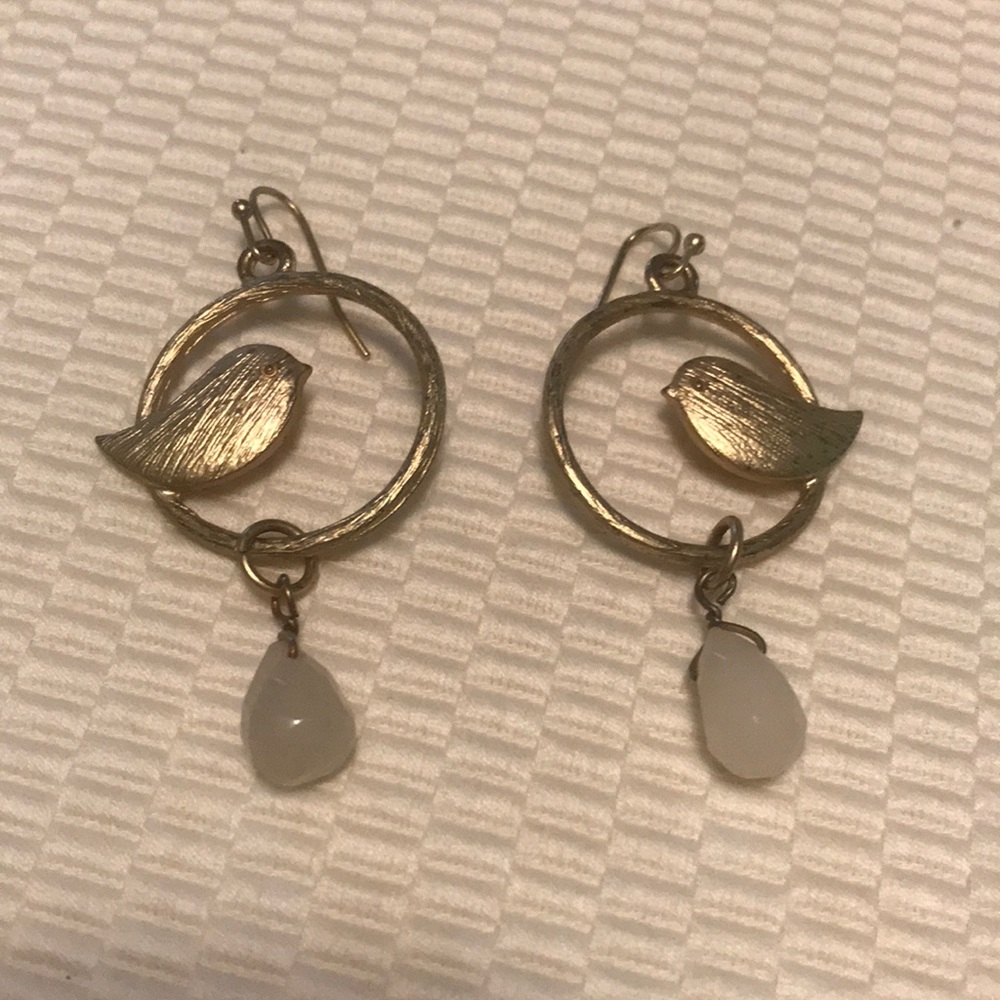 Fashion gold dangle earrings with bird motif.